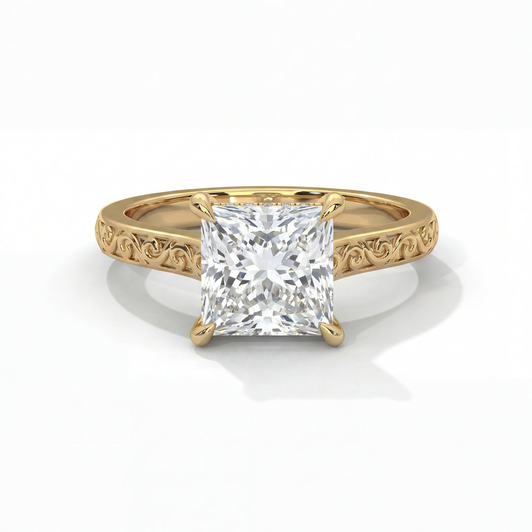 A gold ring with an ornate band features a large, square-cut diamond in a prong setting, exuding elegance and sophistication on a white background.
