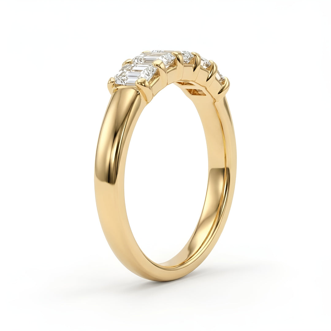 A gold ring with a polished finish, featuring seven rectangular diamonds set in a row on top. The ring conveys elegance and luxury.