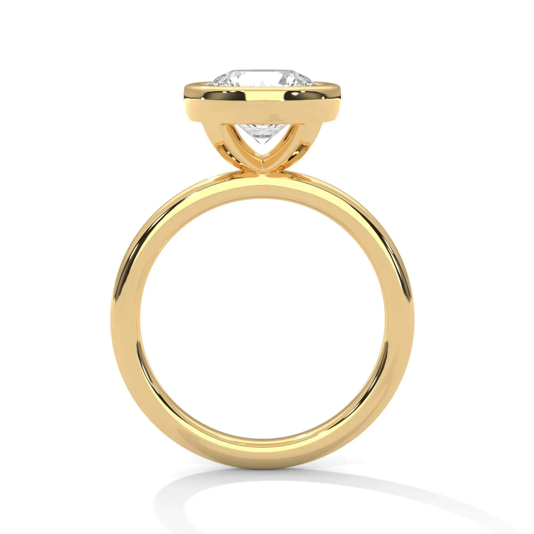 A gold ring with a solitaire diamond setting viewed from the side. The sleek and elegant design highlights the sparkling diamond above the band.