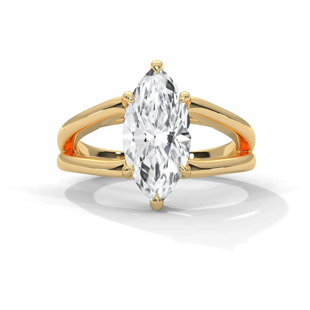 A gold ring with a split shank design features a marquise-cut diamond at its center. The setting is elegant and exudes a timeless and sophisticated charm.