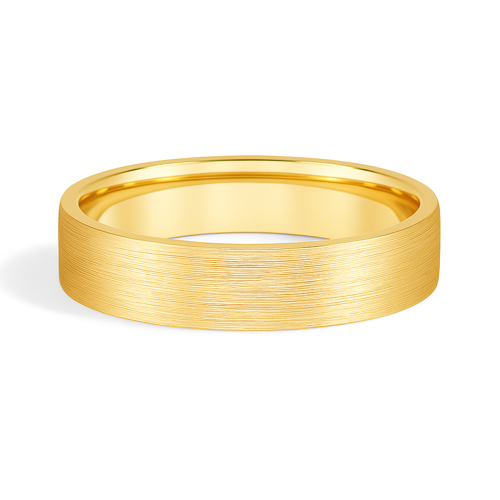 A gold wedding band with a brushed texture, casting a soft shadow on a white background. The surface appears smooth and elegant, conveying simplicity and elegance.