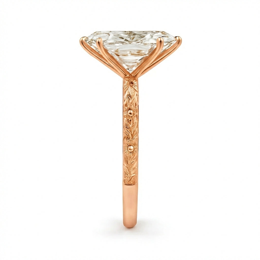 Rose gold ring with a large diamond and intricate design on a white background