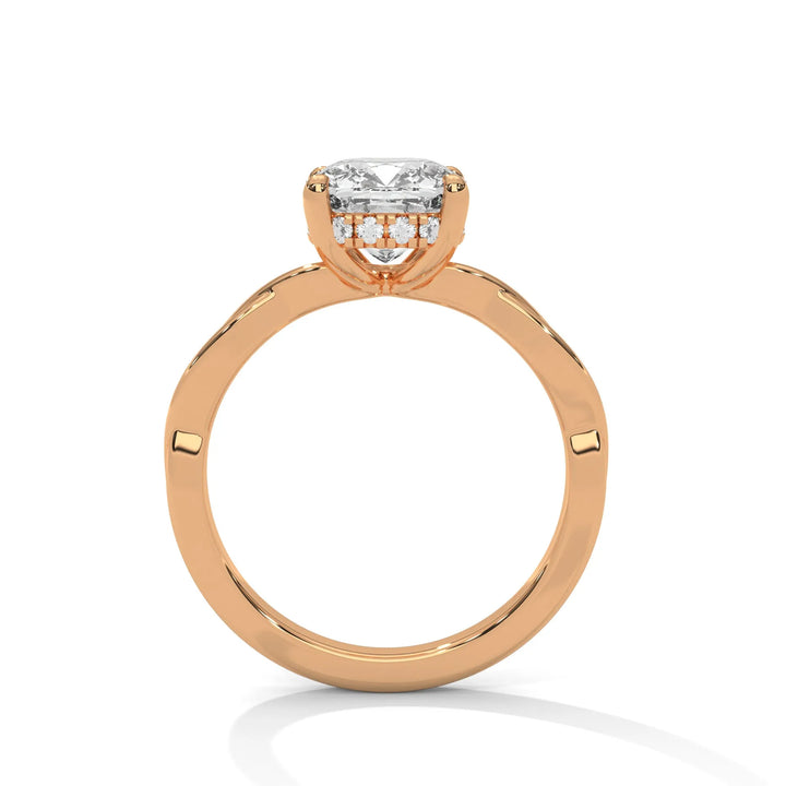 A rose gold engagement ring adorned with a long cushion cut diamond center, featuring the elegant Kosina setting for added charm.