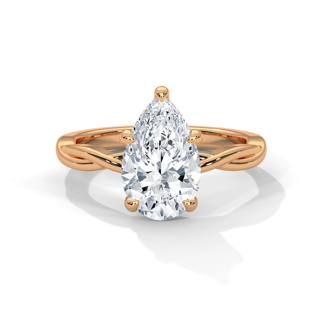 A stunning 14k rose gold engagement ring with a pear cut diamond, beautifully crafted in the Kosina setting.