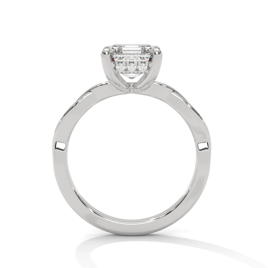 A white gold engagement ring adorned with a asscher cut diamond center, featuring the elegant Kosina setting for added charm.