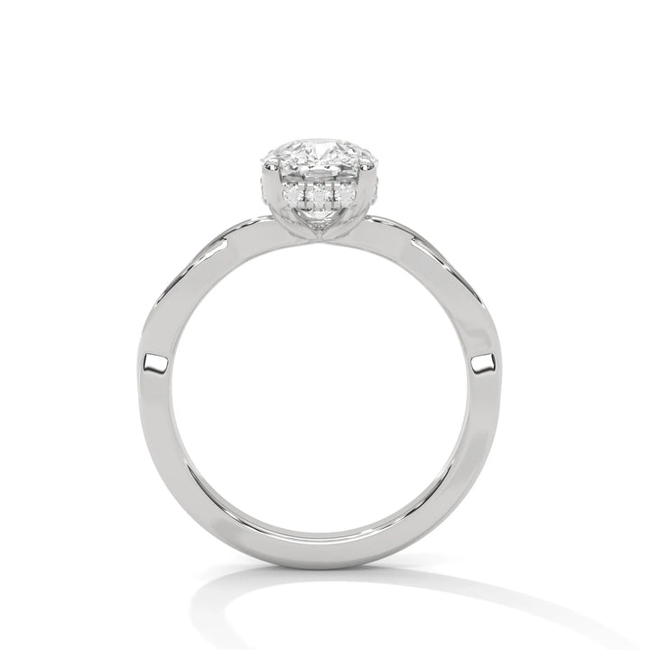 A white gold engagement ring adorned with a cushion cut diamond center, featuring the elegant Kosina setting for added charm.