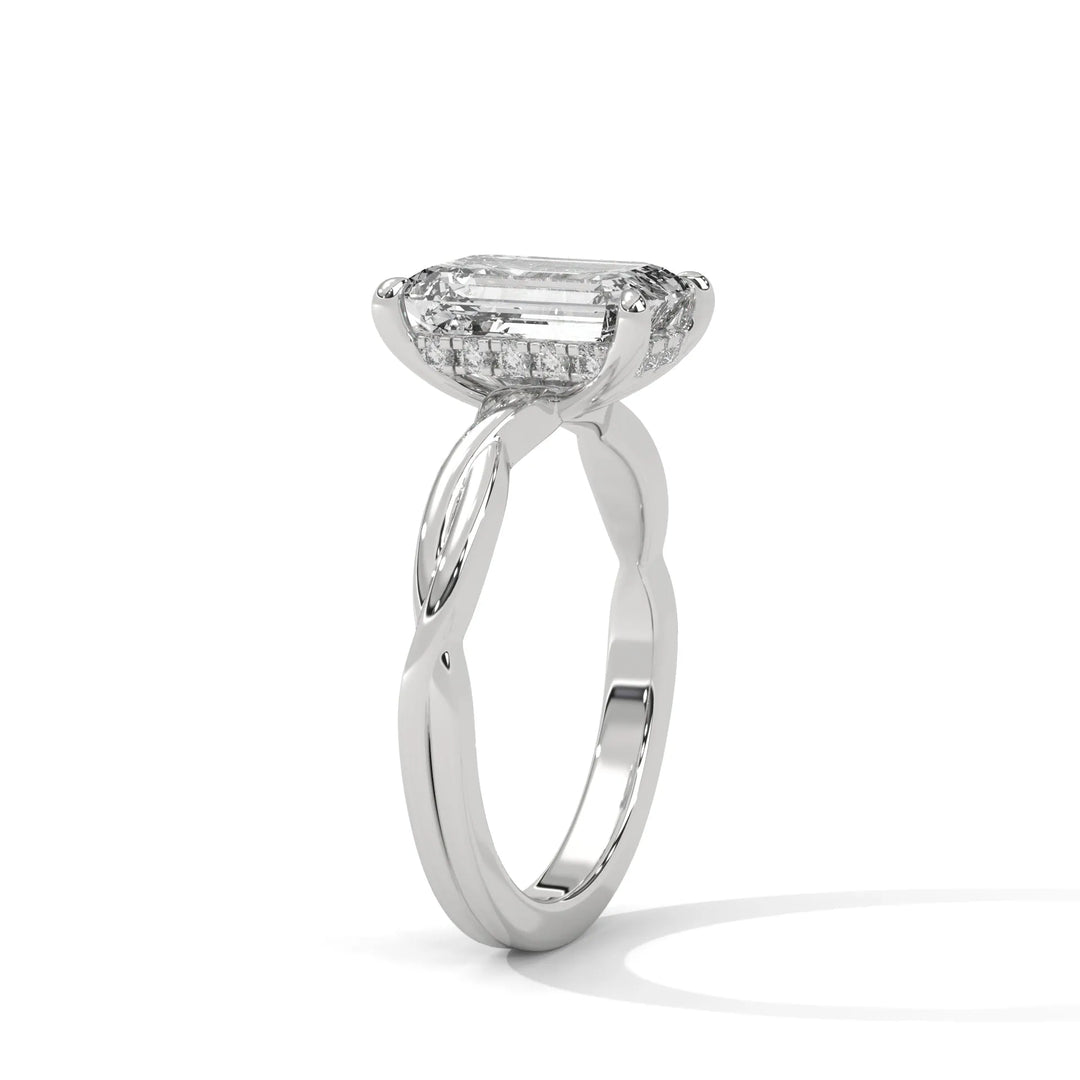 A white gold engagement ring adorned with a emerald cut diamond center, exemplifying the refined Kosina setting craftsmanship.