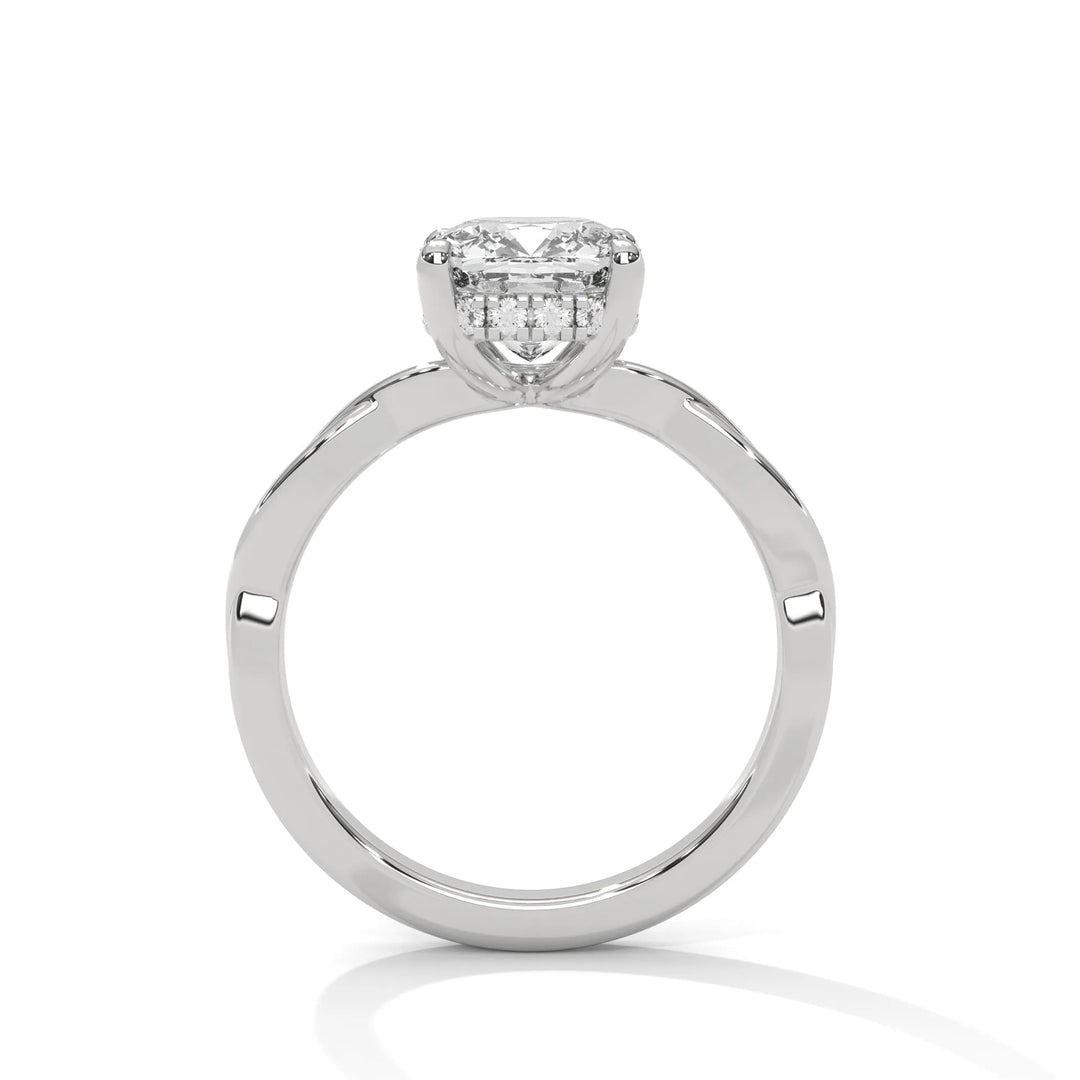 A white gold engagement ring adorned with a long cushion cut diamond center, featuring the elegant Kosina setting for added charm.