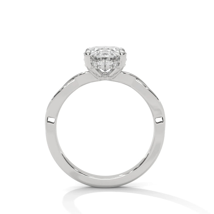 A white gold engagement ring adorned with a oval cut diamond center, featuring the elegant Kosina setting for added charm.