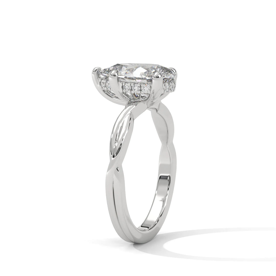 A white gold engagement ring adorned with a pear cut diamond center, exemplifying the refined Kosina setting craftsmanship.