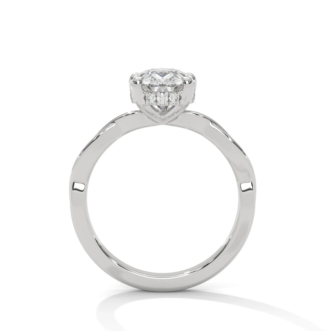 A white gold engagement ring adorned with a pear cut diamond center, featuring the elegant Kosina setting for added charm.