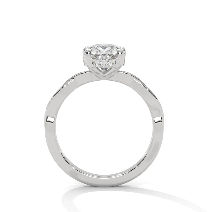 A white gold engagement ring adorned with a pear cut diamond center, featuring the elegant Kosina setting for added charm.