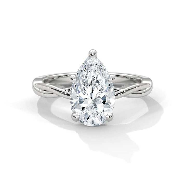 A stunning 14k white gold engagement ring with a pear cut diamond, beautifully crafted in the Kosina setting.