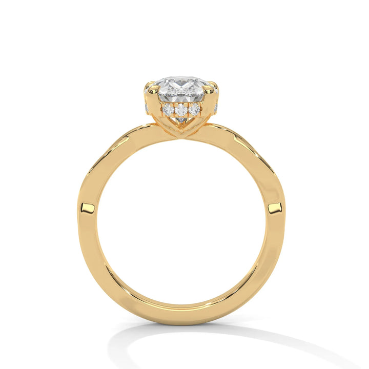 A yellow gold engagement ring adorned with a pear cut diamond center, featuring the elegant Kosina setting for added charm.