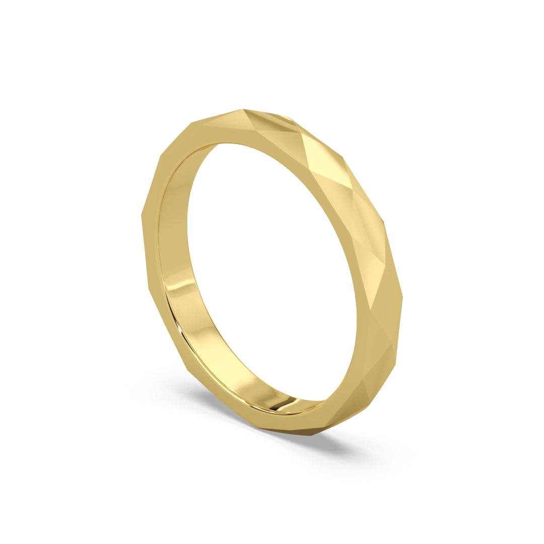 A luxury yellow gold band ring with a faceted design, showcasing a modern and elegant style against a plain white background.