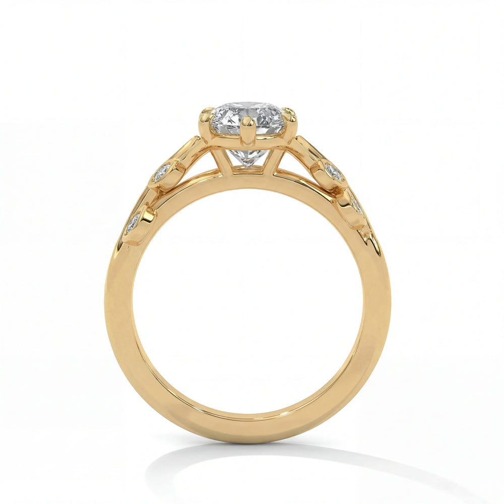 Side profile view of marquise cut diamond engagement ring in yellow gold with nature inspired leaf detailing and pave accents