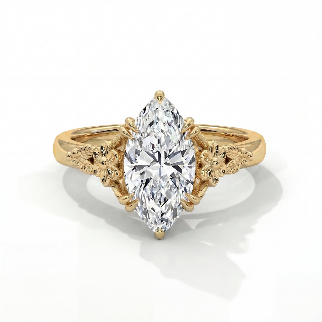 Gold ring with a pear-shaped diamond on a white background