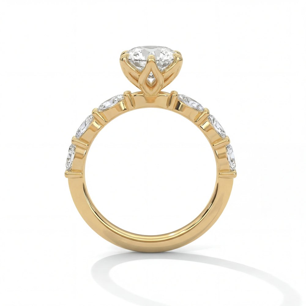 Side profile view of oval cut diamond engagement ring in yellow gold with scalloped band and marquise shaped accents in tulip setting