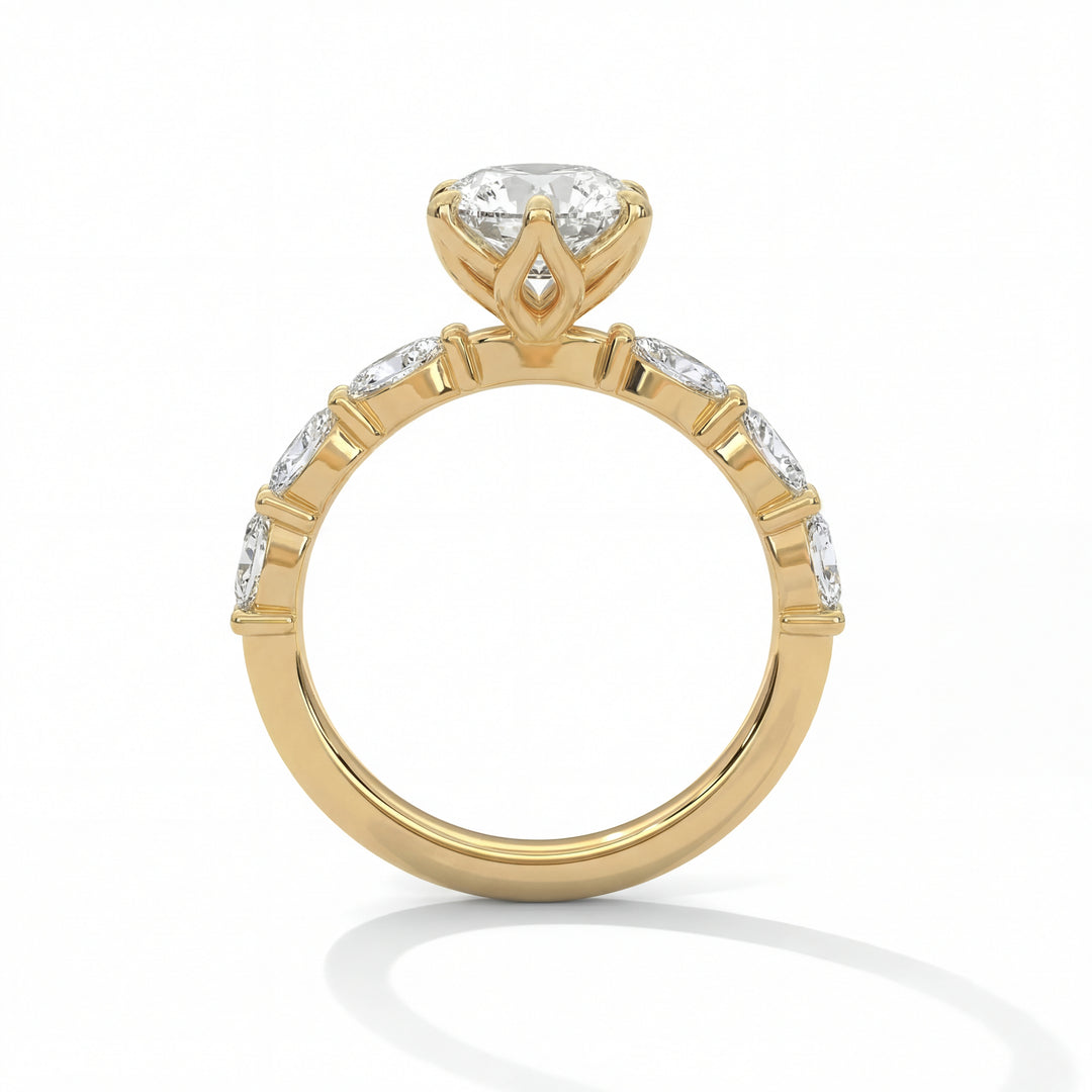 Side profile view of oval cut diamond engagement ring in yellow gold with scalloped band and marquise shaped accents in tulip setting