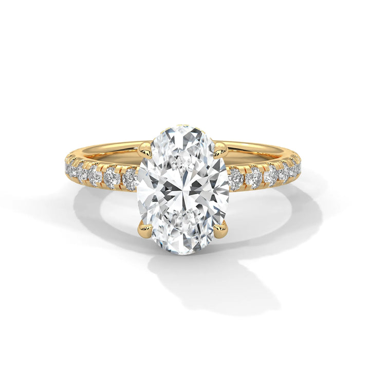 A gold ring featuring an oval-cut diamond in the center, with smaller diamonds set along the band.