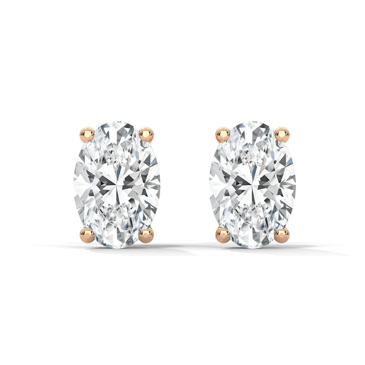 Oval cut diamond stud earrings with rose gold settings on a white background.