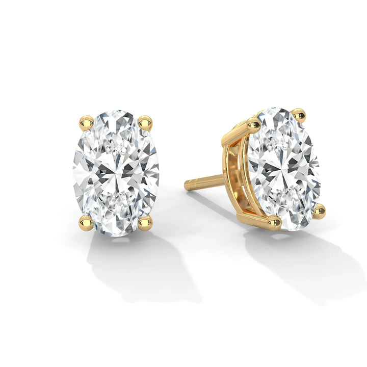 Oval diamond stud earrings set in yellow gold showcasing elegance and sophistication in a timeless design.