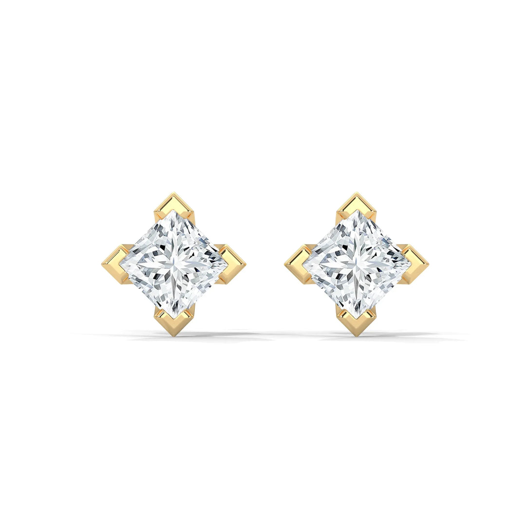 Pair of diamond earrings with gold settings on a white background.