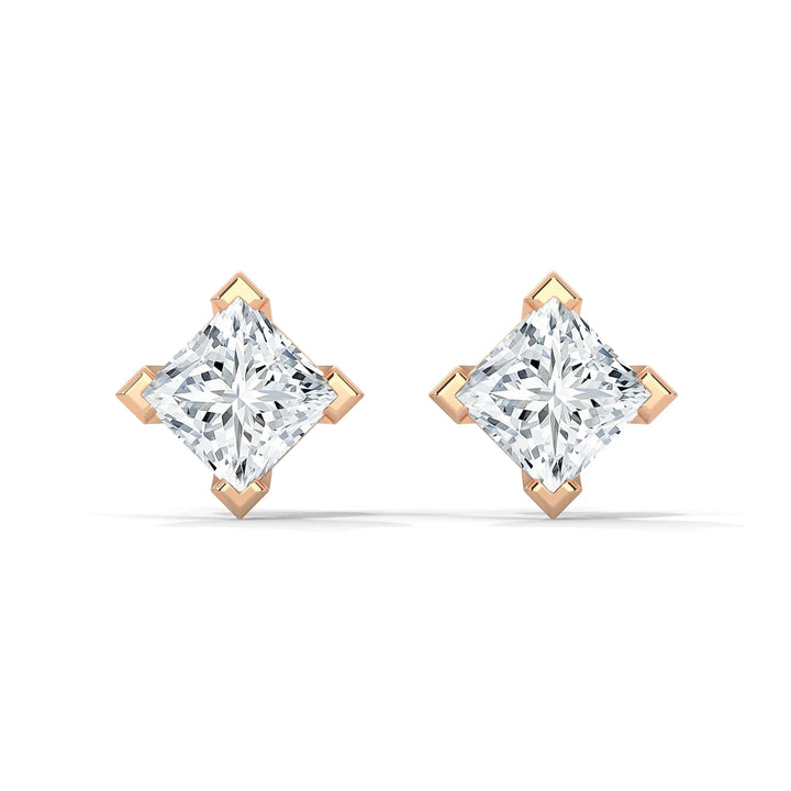 A pair of diamond stud earrings with gold prongs on a white background.