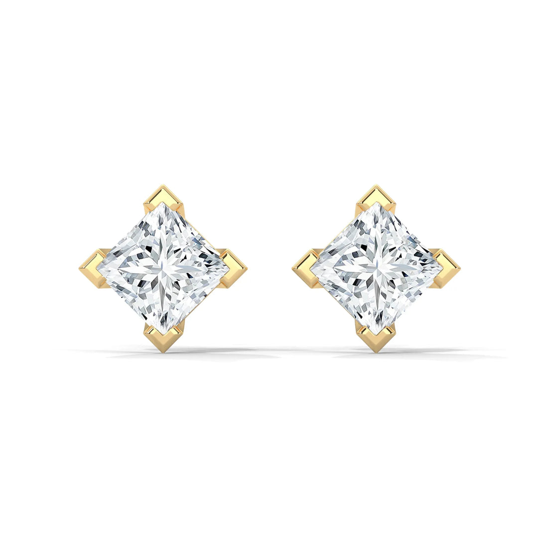 A pair of diamond stud earrings in a gold setting on a white background.