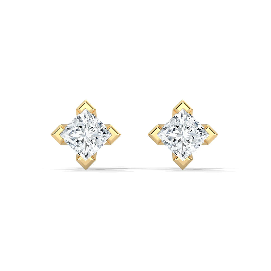 A pair of diamond stud earrings with gold settings on a white background.