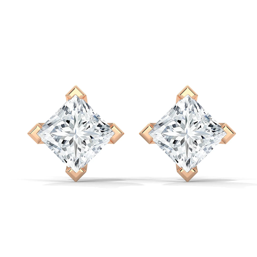 A pair of diamond stud earrings with a rose gold setting on a white background.