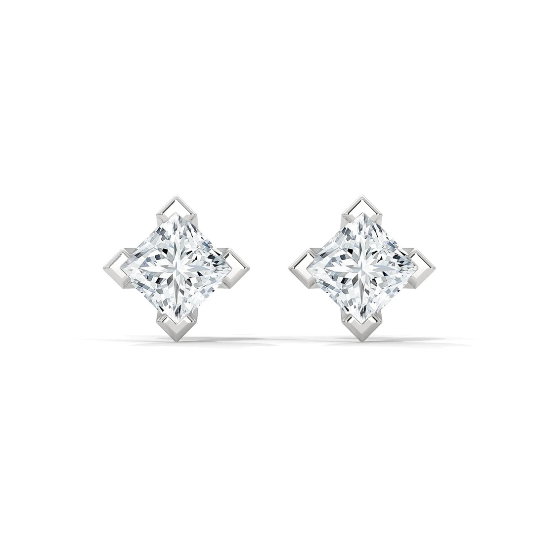 A pair of diamond stud earrings in a square setting on a white background.