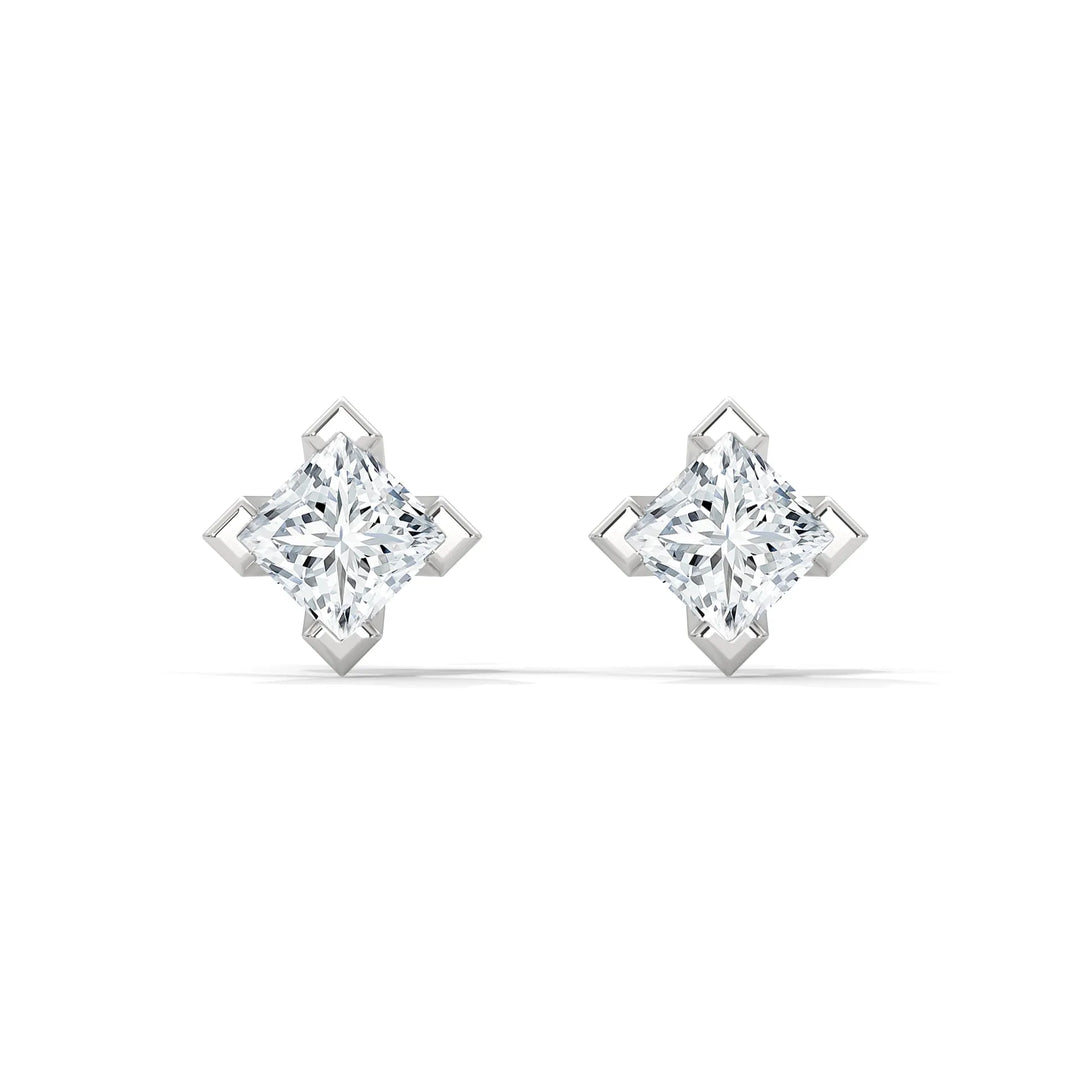 A pair of diamond stud earrings in a star shaped setting on a white background.