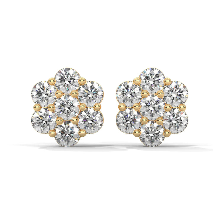 A pair of flower shaped diamond earrings with gold settings on a white background.