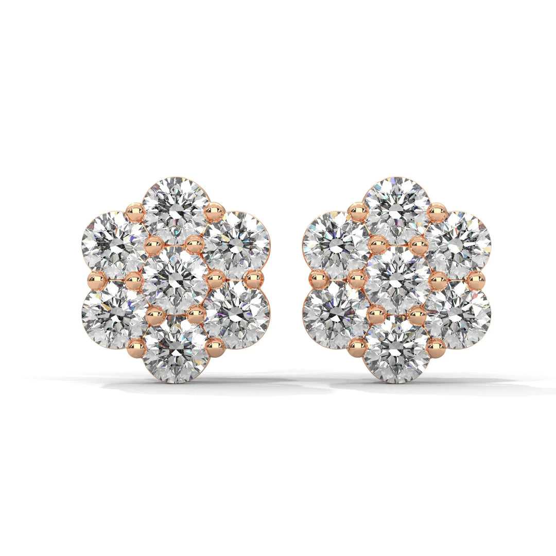 Pair of flower shaped diamond earrings with rose gold setting on a white background.