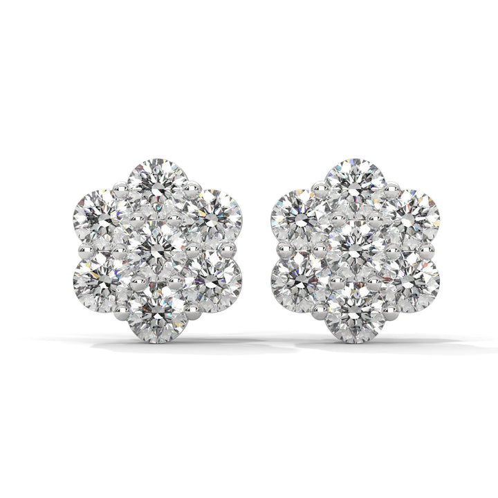 A pair of flower shaped diamond earrings on a white background.