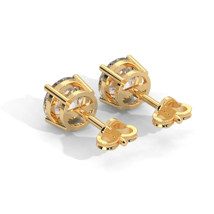 A pair of gold cufflinks with a central stone design on a white background.