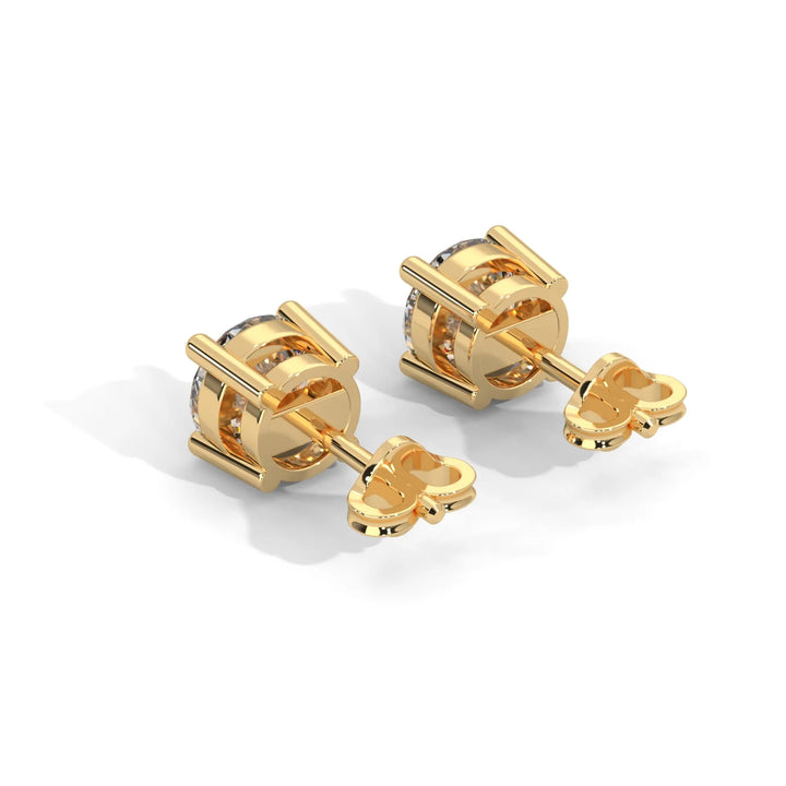 A pair of gold cufflinks with a knot design on a white background.