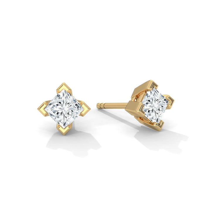 Pair of gold diamond stud earrings on a white background.