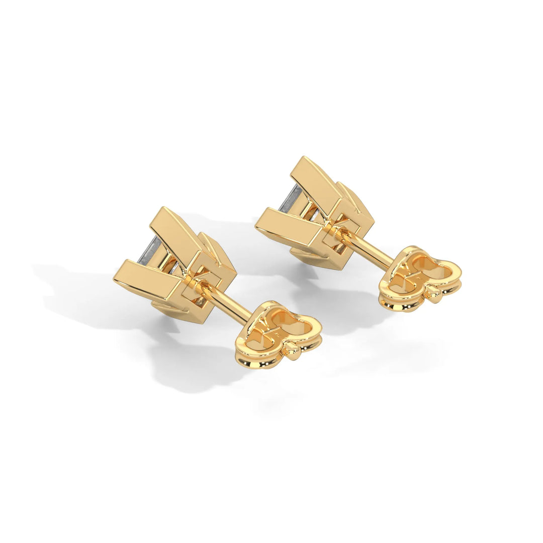 Pair of gold toned cufflinks with a modern design on a white background.