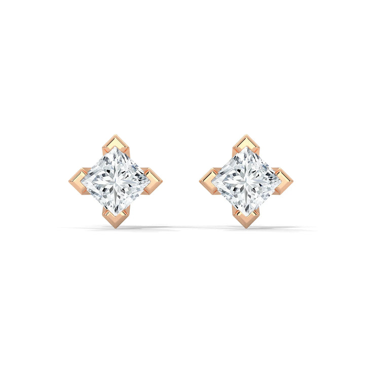 Pair of marquise diamond earrings with rose gold settings on a white background.