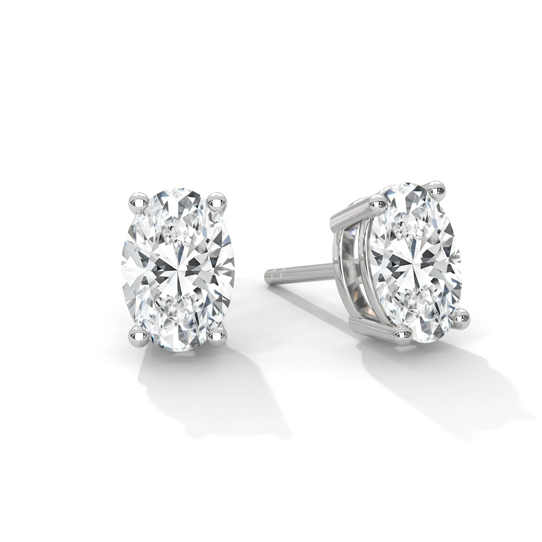 A pair of oval cut diamond stud earrings set in white gold.