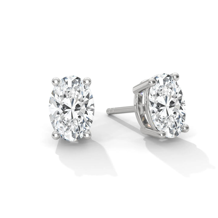 A pair of oval cut diamond stud earrings set in white gold.