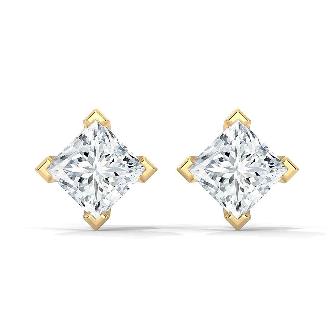 A pair of princess-cut diamond earrings set in gold.