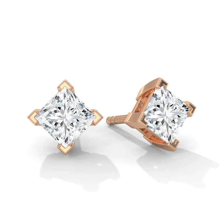 Pair of princess cut diamond stud earrings in a rose gold setting, on a white background.