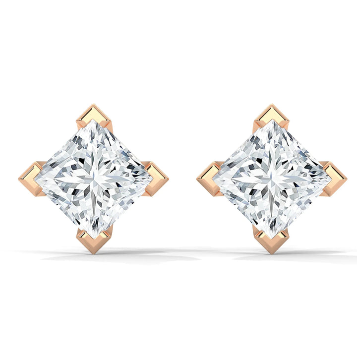 A pair of princess cut diamond stud earrings set in rose gold.