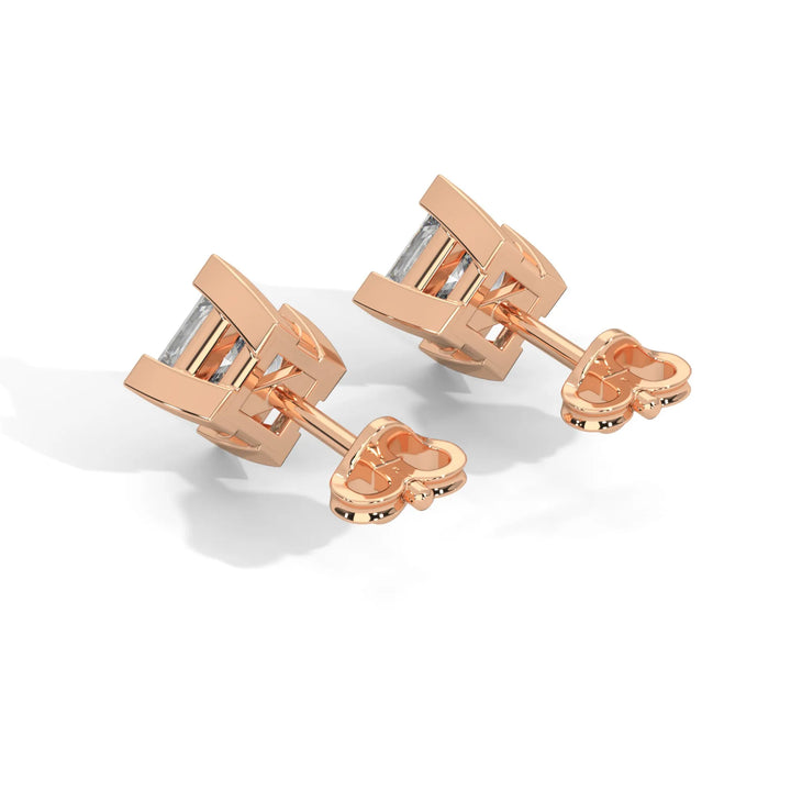 A pair of rose gold cufflinks with a geometric design on a white background.