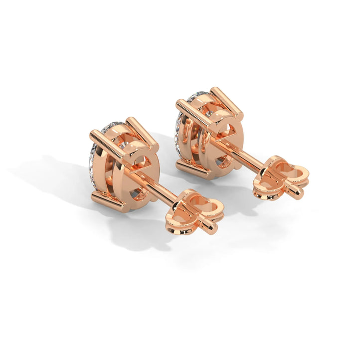 A pair of rose gold cufflinks with a knot design on a white background.