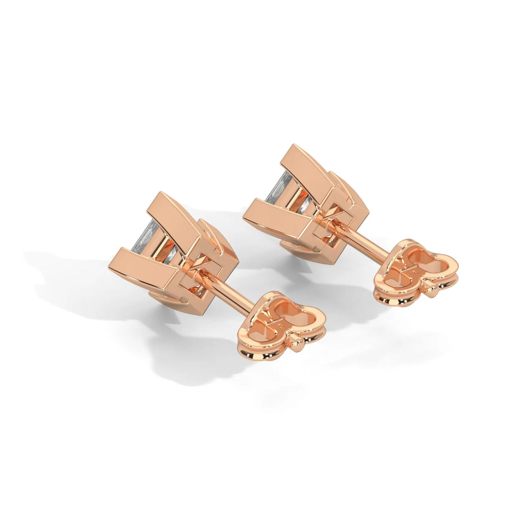 A pair of rose gold cufflinks with a polished finish on a white background.