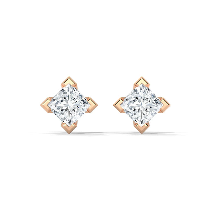 A pair of rose gold diamond earrings with princess cut stones on a white background.